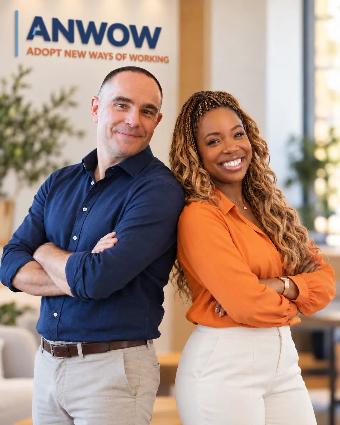 The two ANWOW founders, Vincent and Lizebeth, standing back to back and smiling in an office